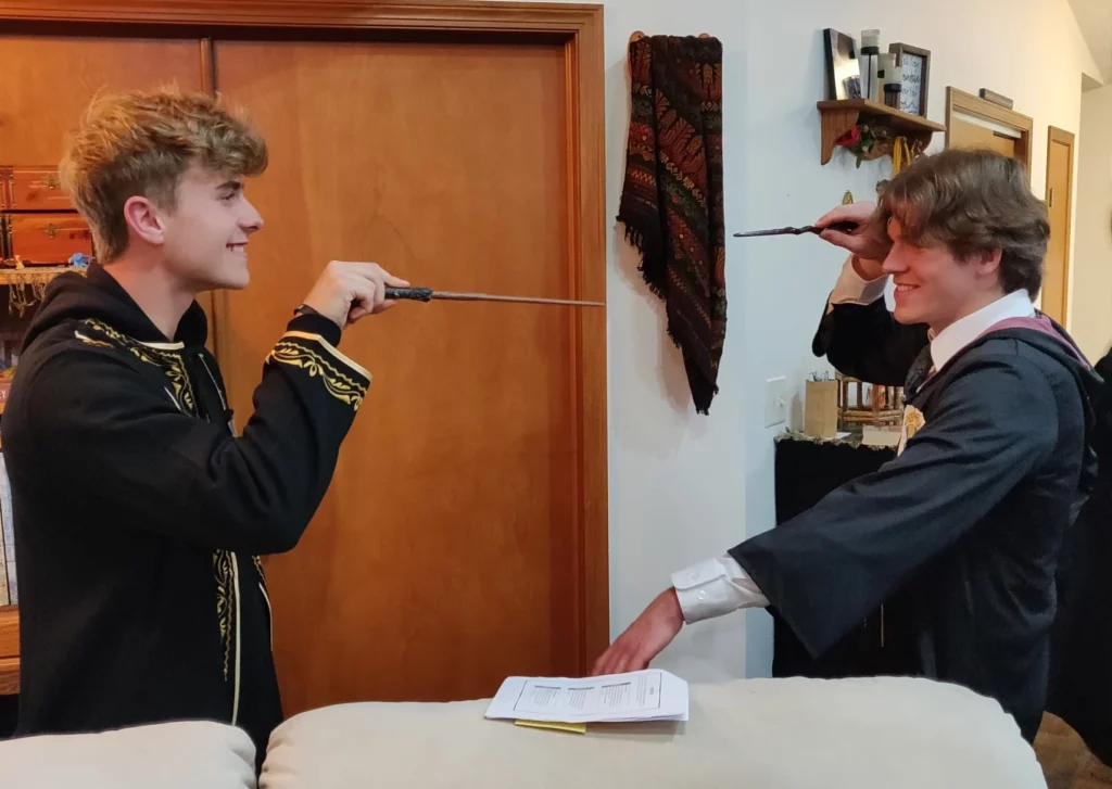 Wizard students pointing wands at each other