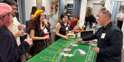 Players in costume at a blackjack table playing our Casino Fatale murder mystery game