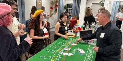 Casino Fatale Players in costume at a blackjack table playing our Casino Fatale murder mystery game