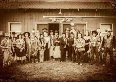 Sepia tinted photo of people playing our Way out West murder mystery game.