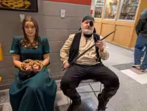 Two people in pirate costumes, one captured