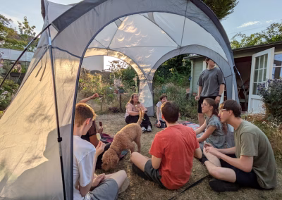 Relaxing after playing The Deadly Library - with little eclipses projected onto the event shelter.